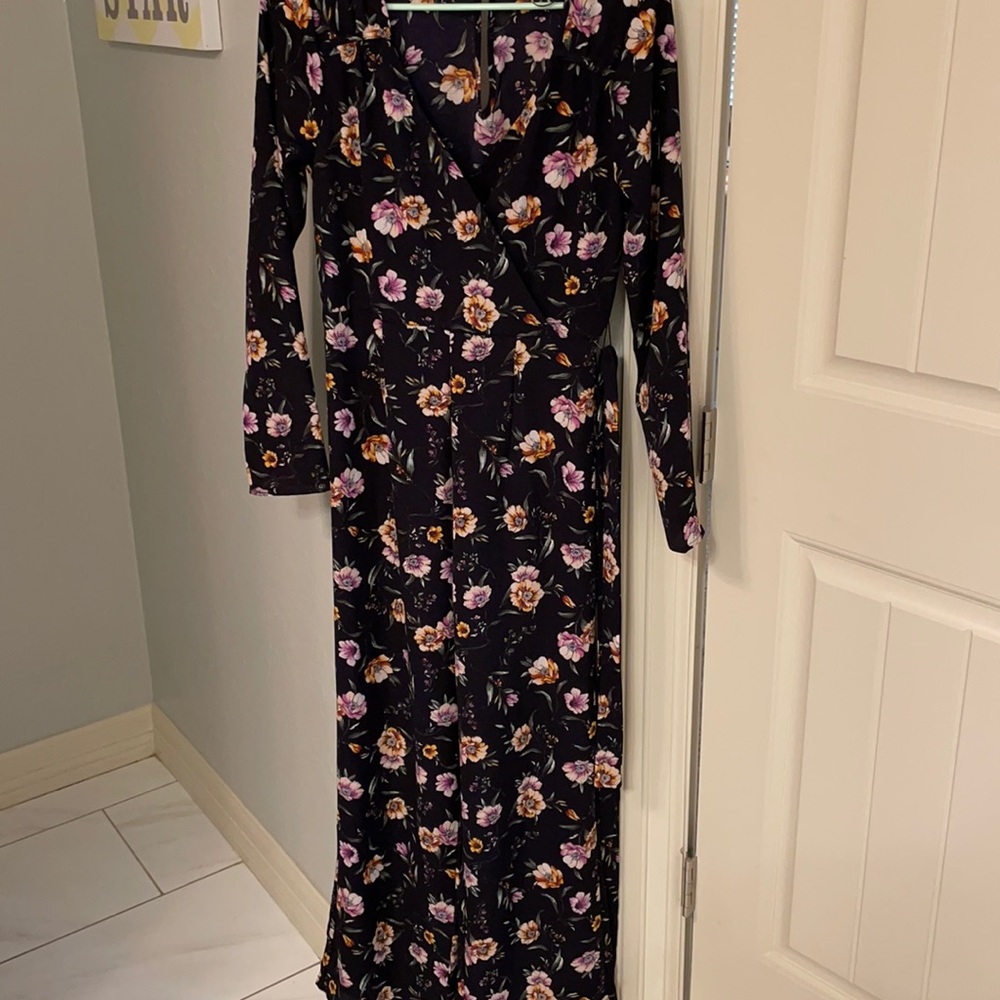 Navy and floral jumpsuit with tie at waist. V neck and button on back of neck